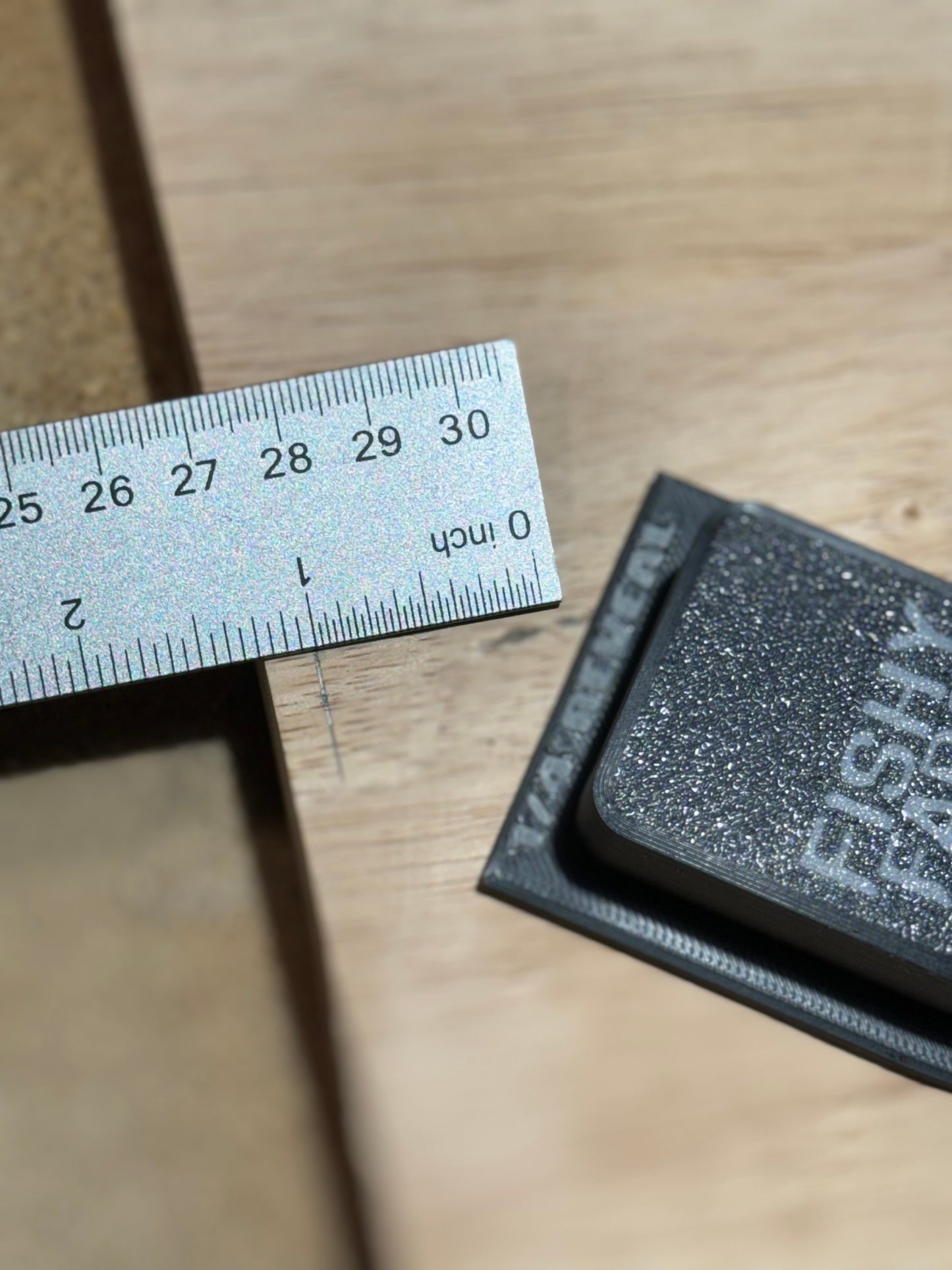  In this photo, a user is measuring a 1/4 inch reveal using the TrimMate Pro by FishyFabsPNW. The 1/4 inch reveal plate is securely attached to the tool with four 6mm M3 screws. The embedded magnet allows the tool to double as a stud finder, providing precision and versatility for finish carpentry projects.