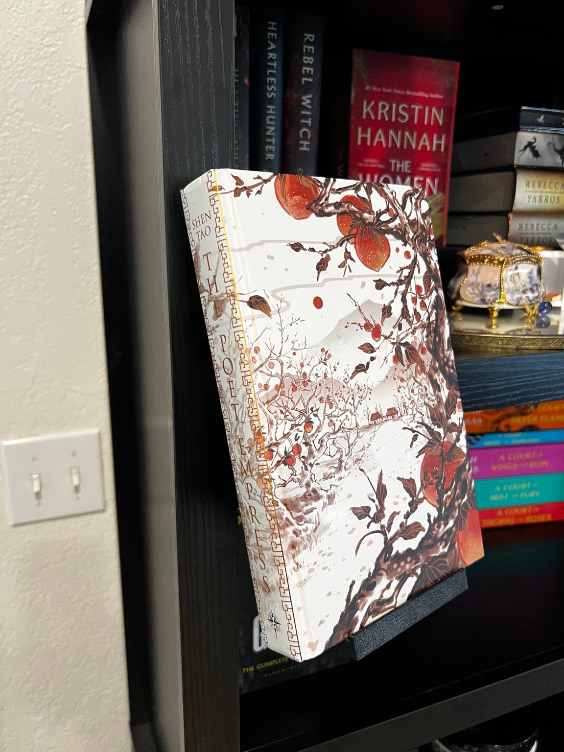 Clamp-on display holding a white-covered book